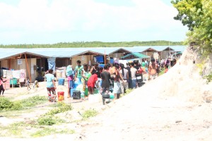 Badjao families at their transitory site in Brgy. Mampang, Zamboanga line up to collect water for each of their households