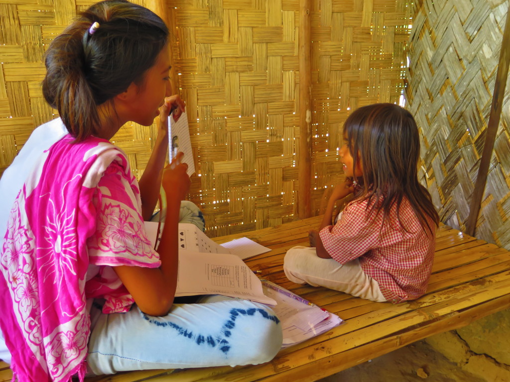 A research assistant guides a Tagbanua young learner through a series of cognitive and literacy tests in Sitio Cagait, Culion