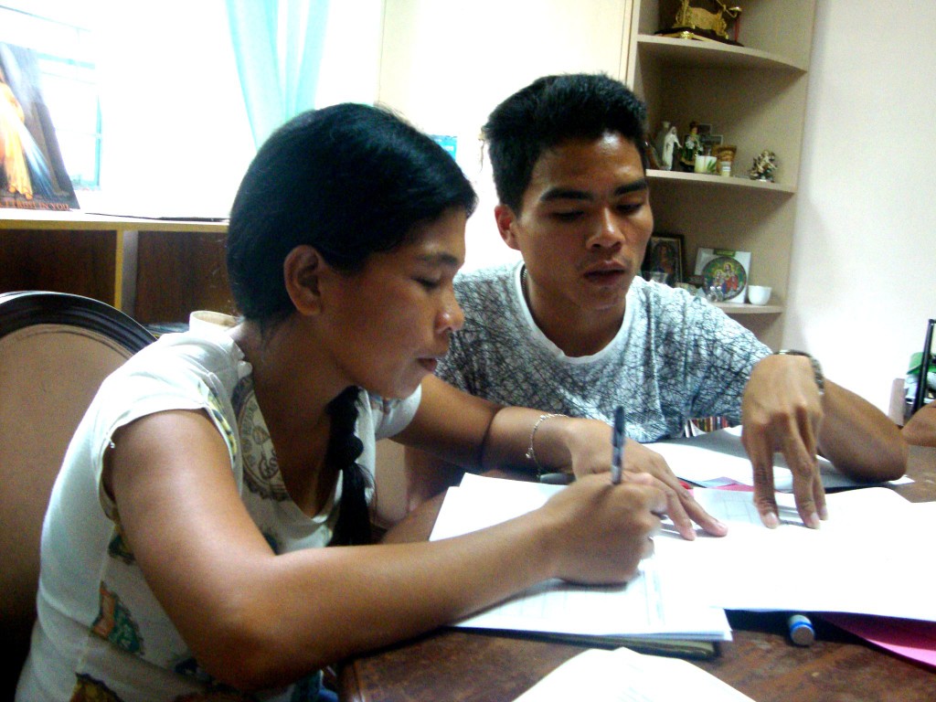 Higaonon teachers Mia Soriano and Naldo Laipan help each other in filling out the program assessment form at the Indigenous Peoples Apostolate office in Butuan City