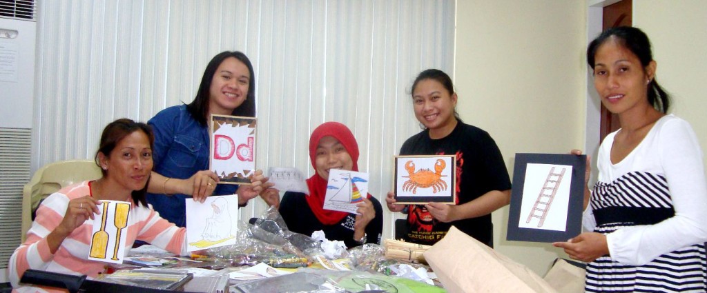 Teachers Relinda (leftmost) and Sariba (rightmost) work on creating various instructional materials and visual aids with the help of Fatima from ADZU-CCES (center), flanked by Bricks and Celia of Cartwheel