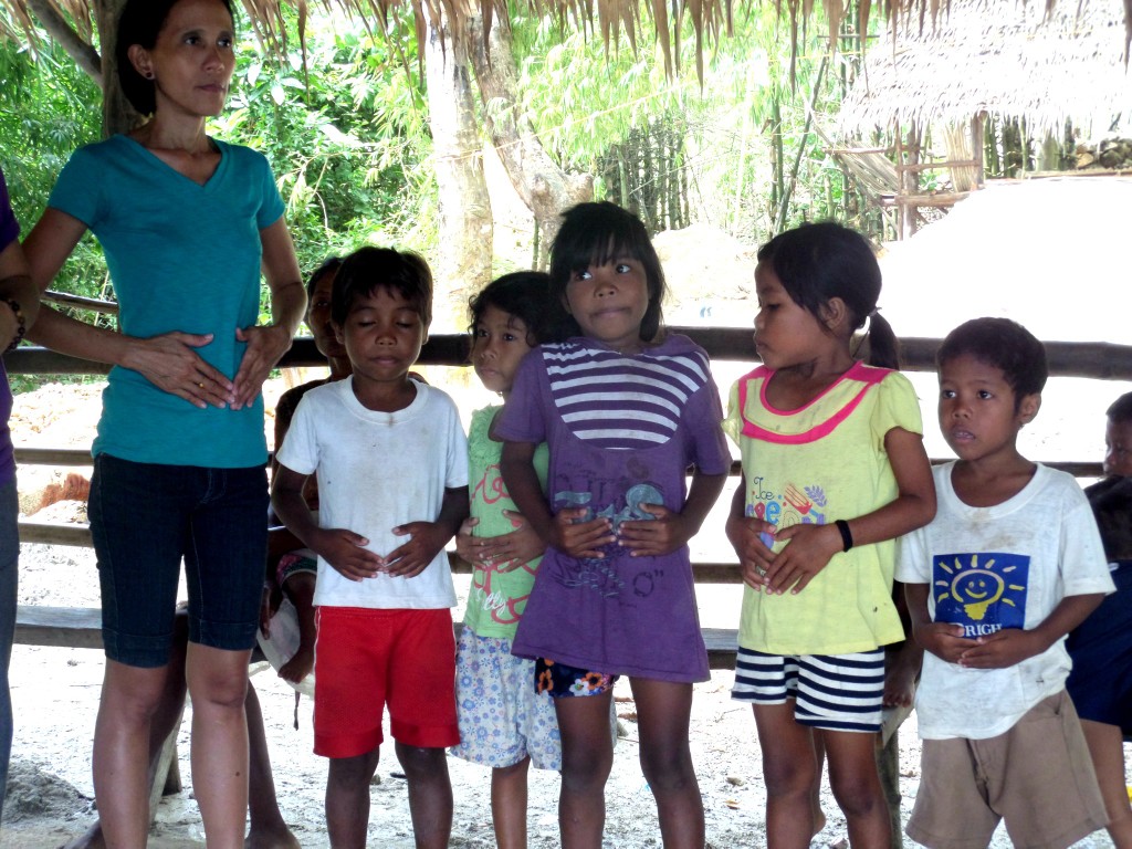 Children from Sitio Chindonan follow as facilitators lead the community through deep breathing and grounding exercises
