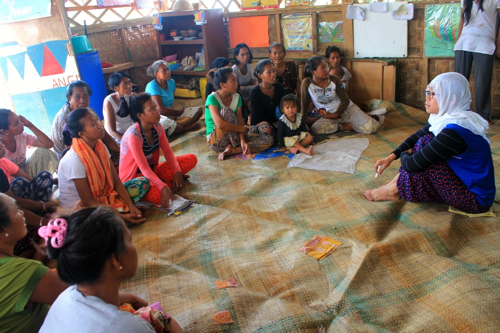 Fatima (rightmost, seated), leads a consultation session with the Bajau parents