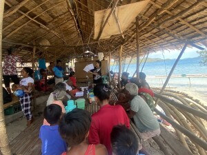 The Project Manager, Teresa Banta, reviews the draft of the book page by page with the community during Final Validation